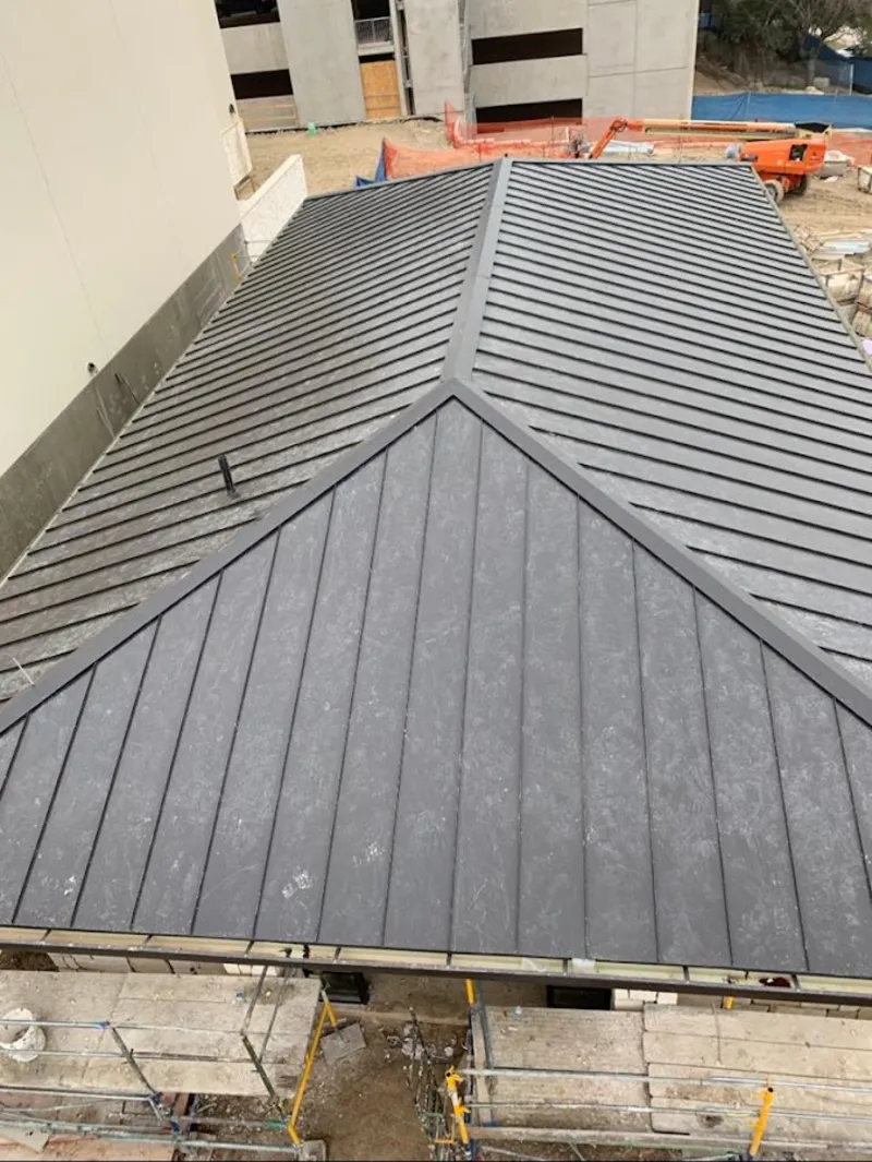 Commercial metal roof construction with crane equipment in Lake Monticello